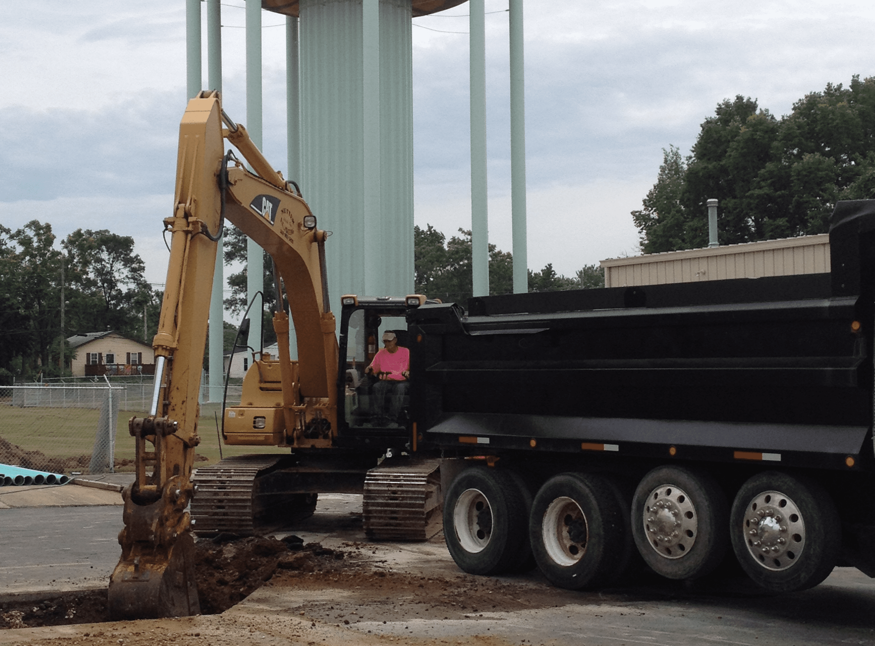 Excavator loading dirt into a dump truck.