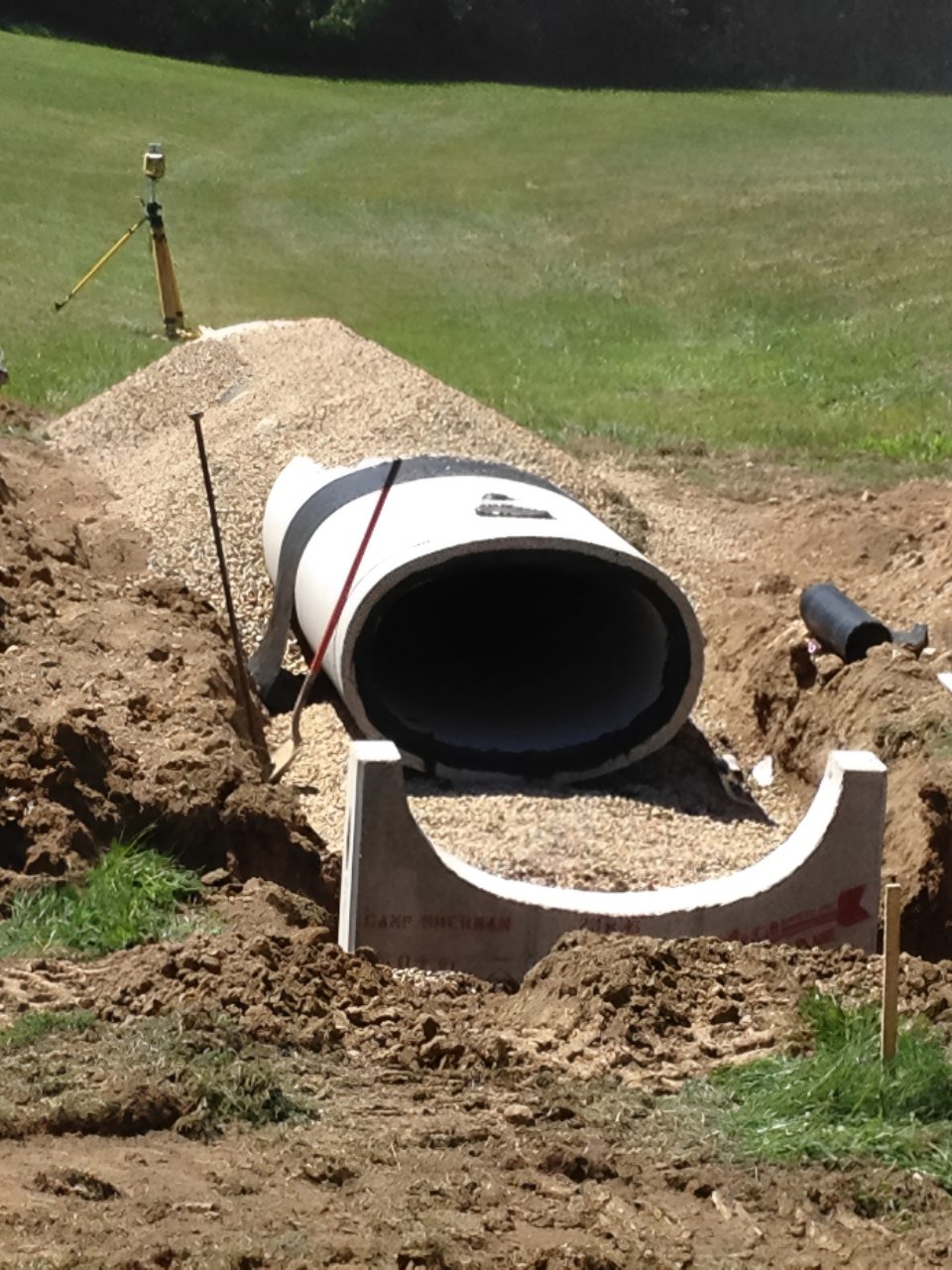 Culvert installation in progress with tools nearby.